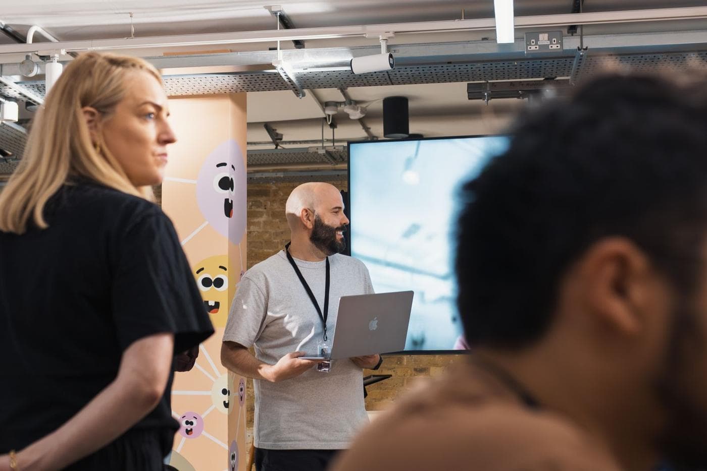 An instructor helping attendees at their laptops